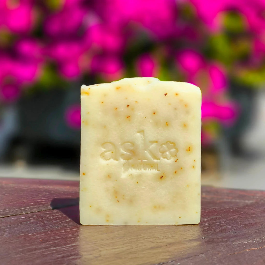 Rose Naturseife mit Rosen im Hintergrund – handgemachte feste Seife mit Blütenstücken für sanfte Pflege.